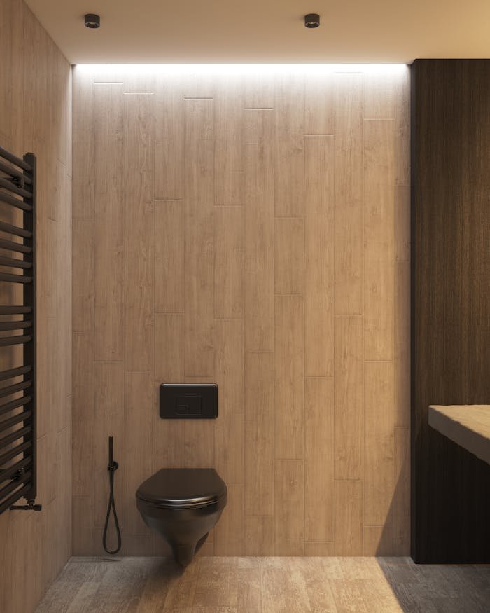 Services-02 Spacious minimalist bathroom featuring a sleek black toilet and wooden walls. Ideal for interior design inspiration.