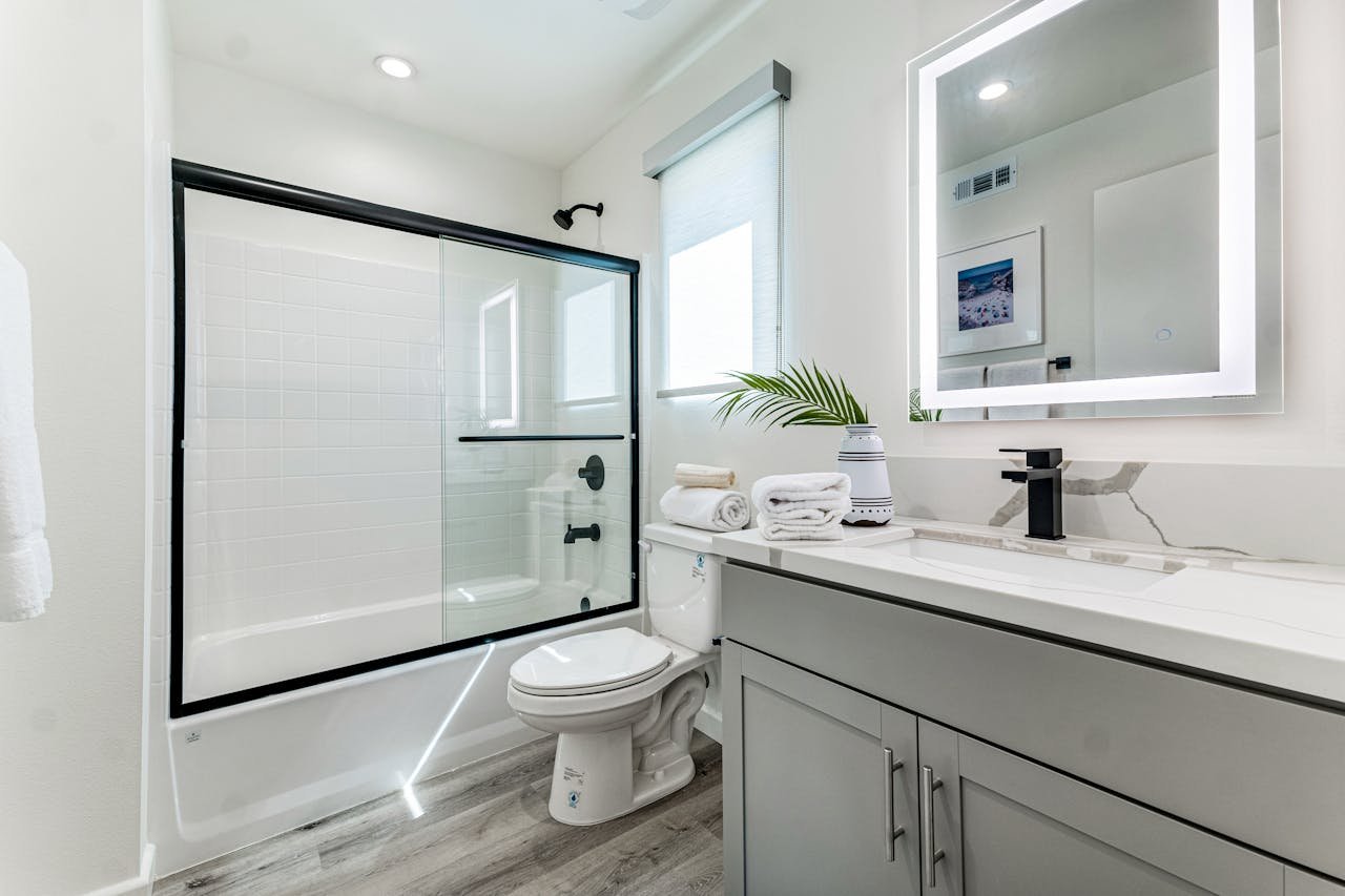 Services-03 Sleek and stylish bathroom featuring a minimalist design with a shower, vanity, and mirror.