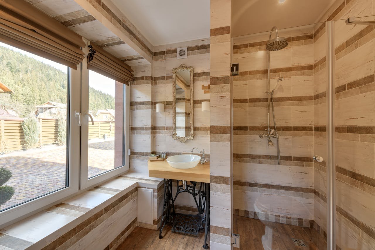 Services-01 Stylish bathroom featuring a shower and mirror with natural light.