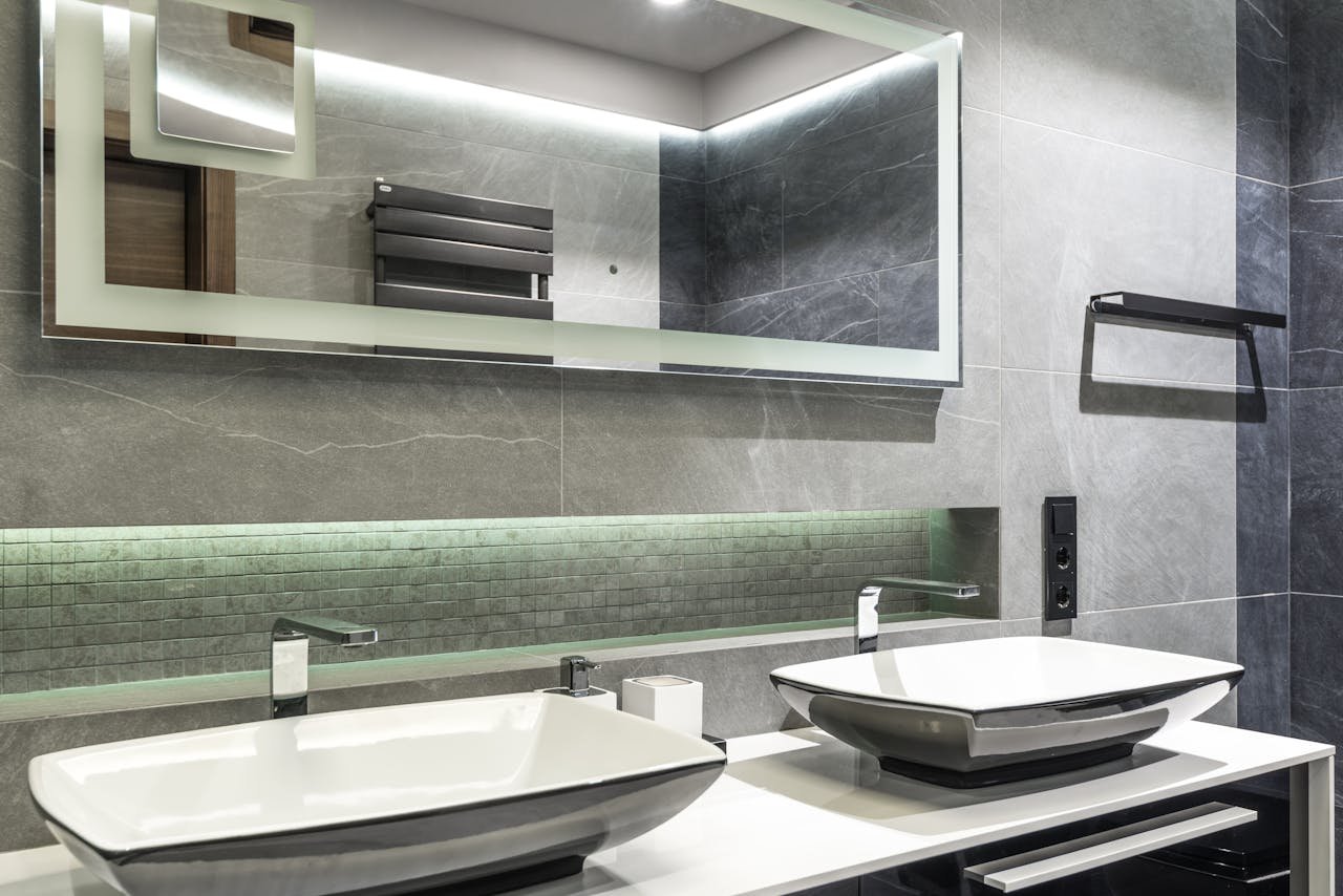 digital Stylish double sink bathroom with a sleek mirror and contemporary design.