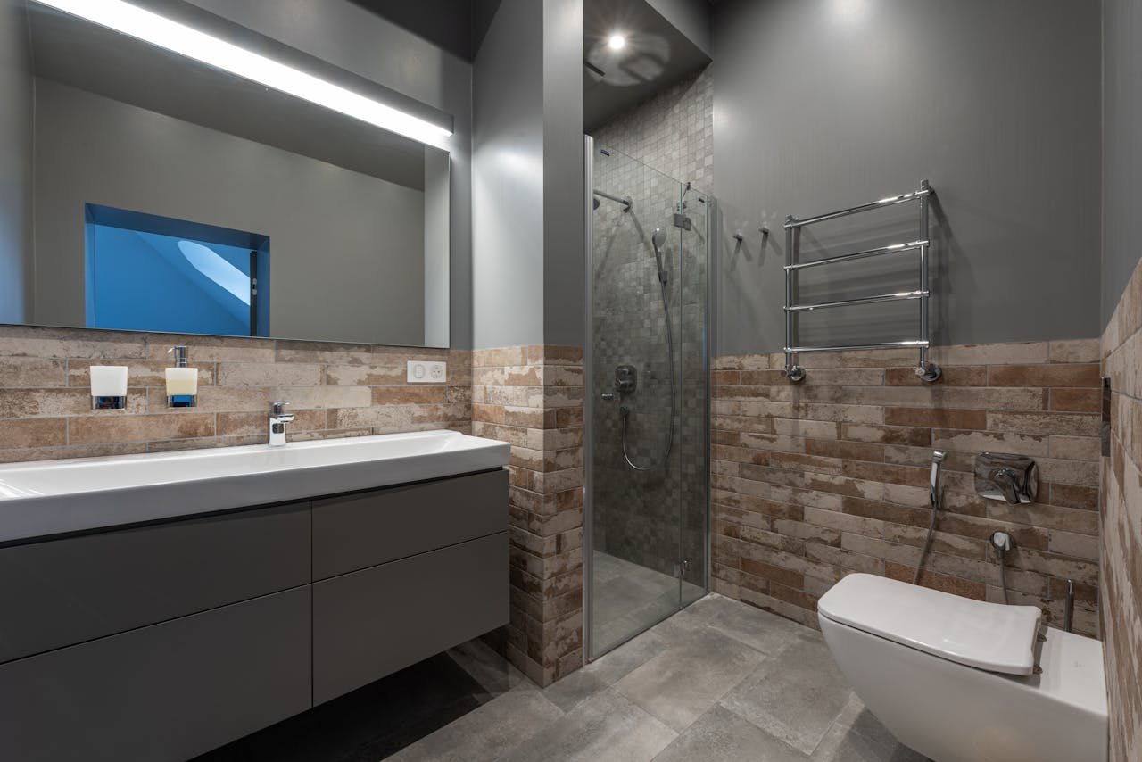 our-story Sleek modern bathroom featuring a glass shower, floating vanity, and stylish decor.